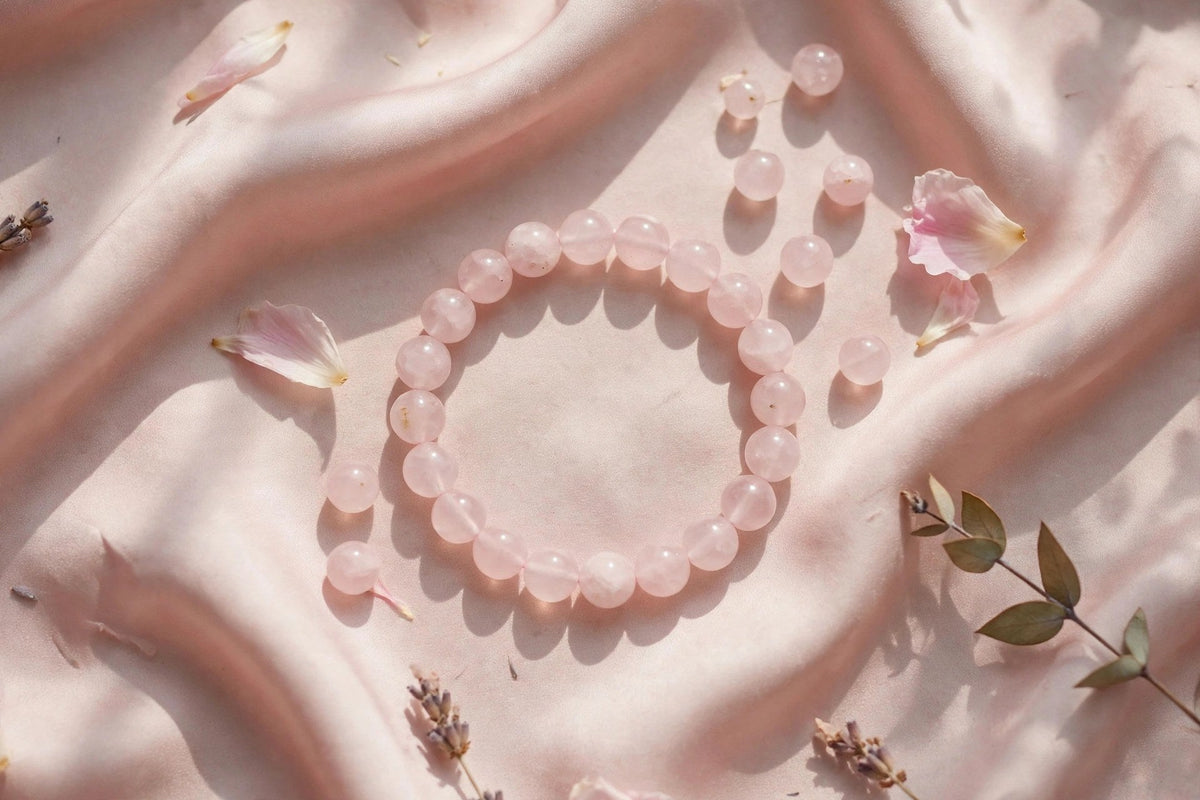 Rose quartz bead bracelet on pink silk
