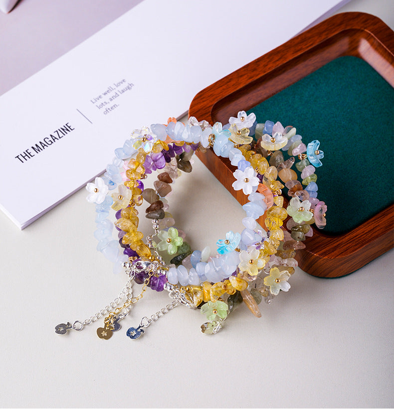 Original crystal-chip bracelet with decorative flower accents; physical product photograph preserved