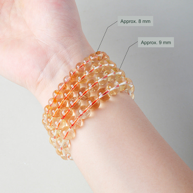 Yellow bead bracelets pictured approximately 8 mm and 9 mm for size comparison