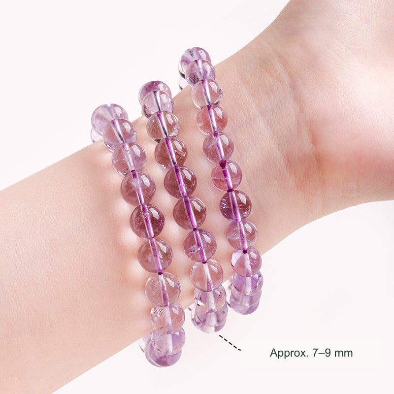 Amethyst bracelets on wrist — approximately 7–9 mm beads; styling comparison
