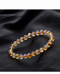 Citrine supplier-described bracelet on black fabric; original product photo preserved