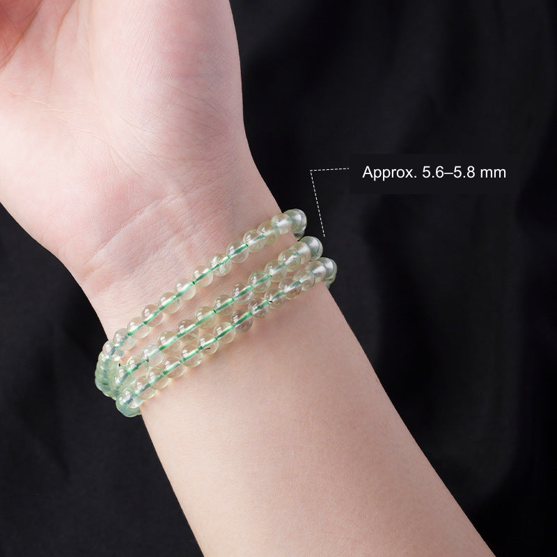 Pale green wrap bracelet worn on a wrist; pictured beads approximately 5.6–5.8 mm