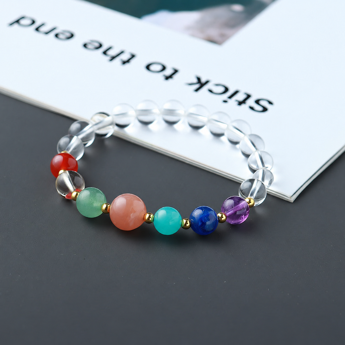 Clear-looking bead bracelet with colored front accents, supplier stamp locally retouched