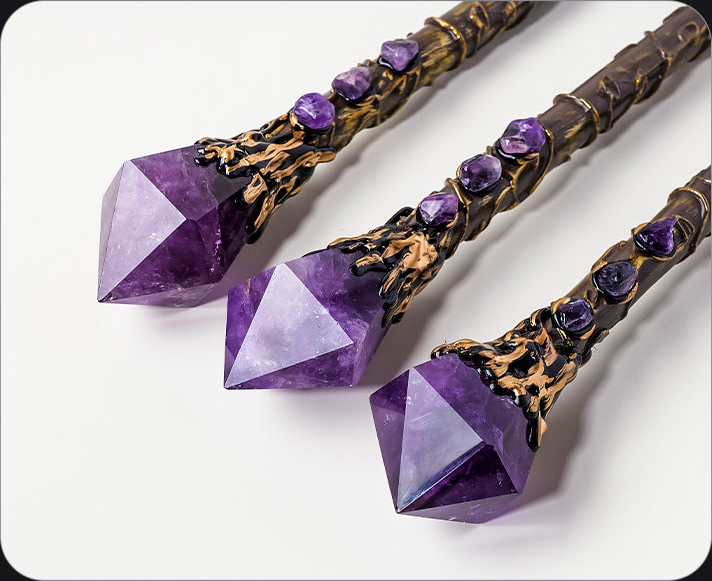 Close-up of faceted purple wand heads and decorative vine-style handles