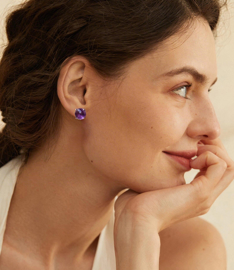 Amethyst stud earrings worn on ear