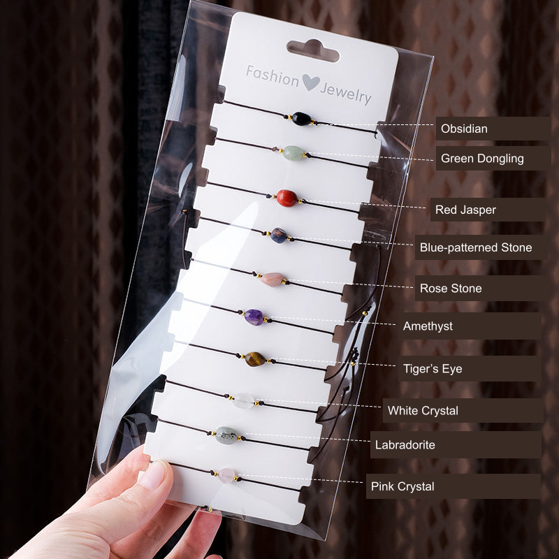 Ten single-bead cord bracelets — all ten original supplier material labels translated into English; actual beads, cords and packet unchanged