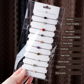 Ten single-bead cord bracelets — all ten original supplier material labels translated into English; actual beads, cords and packet unchanged