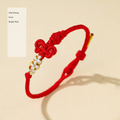Original Chinese-inspired cord bracelet photograph with English style labels; bead inscriptions retained as physical design
